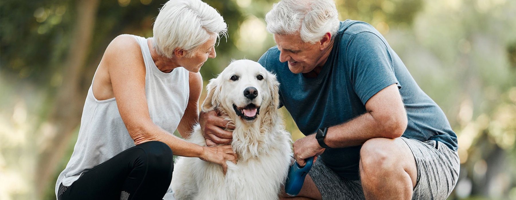 a man and woman petting a dog
